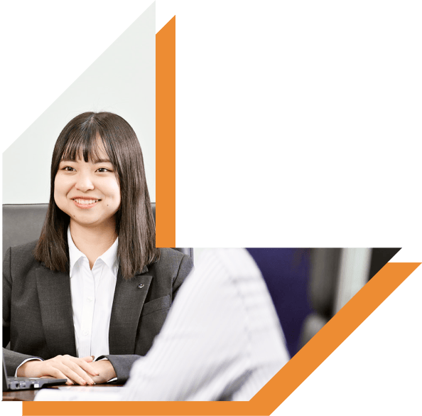 笑顔で会話をするスーツ姿20代女性の写真